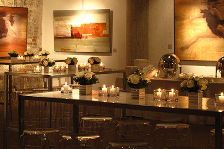 Arta gallery flowers and candles on tables for an event