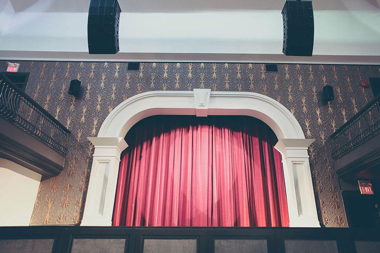 The Great Hall front stage with red curtain in the main venue space