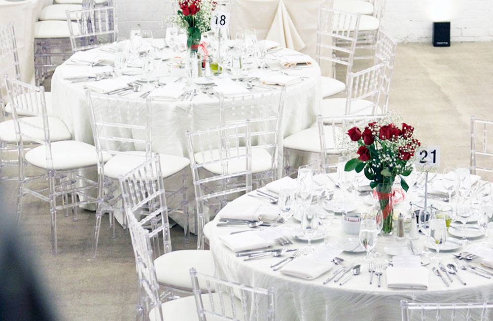 Why is Wedding Catering So Expensive Blog Post - White Table Setting with Red Roses at Wedding In Toronto